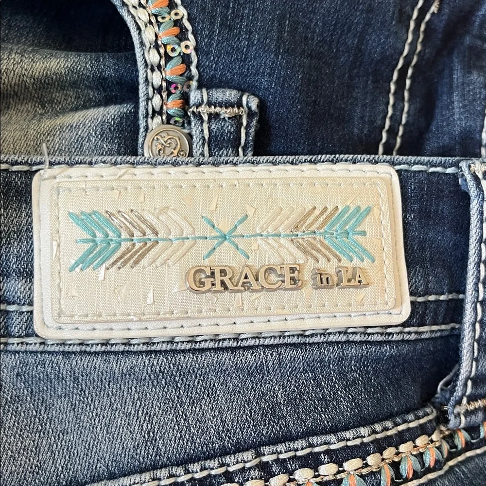 Grace in LA bootcut blue jeans with sequin and embroidery designs. Women’s 29
